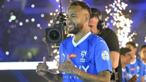 Neymar poses for photographs at his official unveiling as an Al-Hilal player