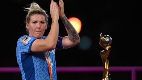 Millie Bright applauds fans as she collects her runners-up medal