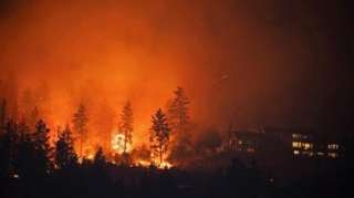 The McDougall Creek wildfire burns next to houses in the Okanagan community of West Kelowna, British Columbia, Canada, August 19, 2023.