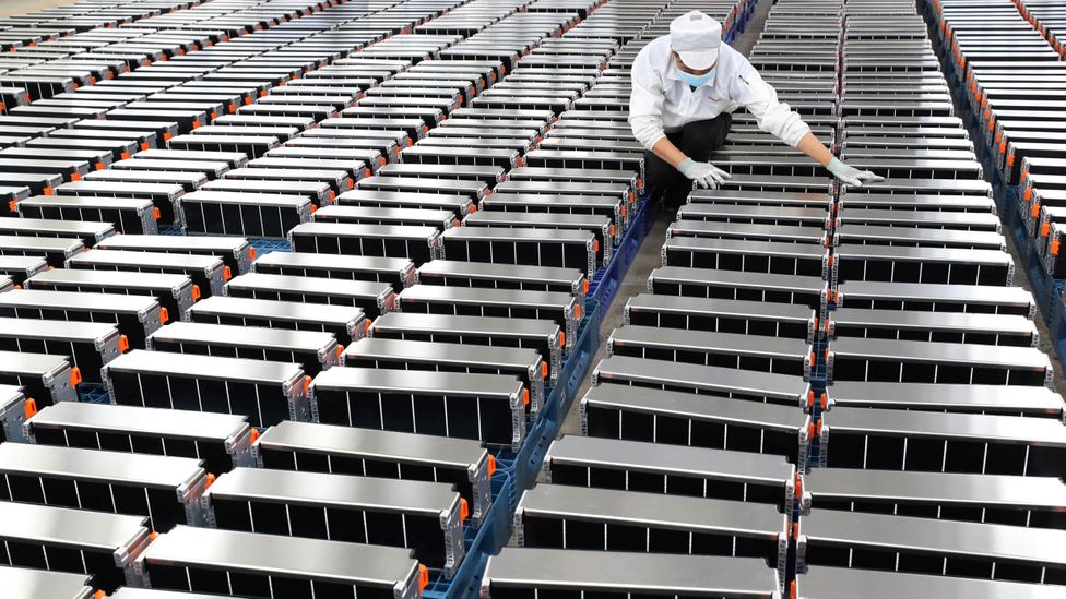 A factory worker checks row upon row of lithium batteries (Credit: Getty Images)