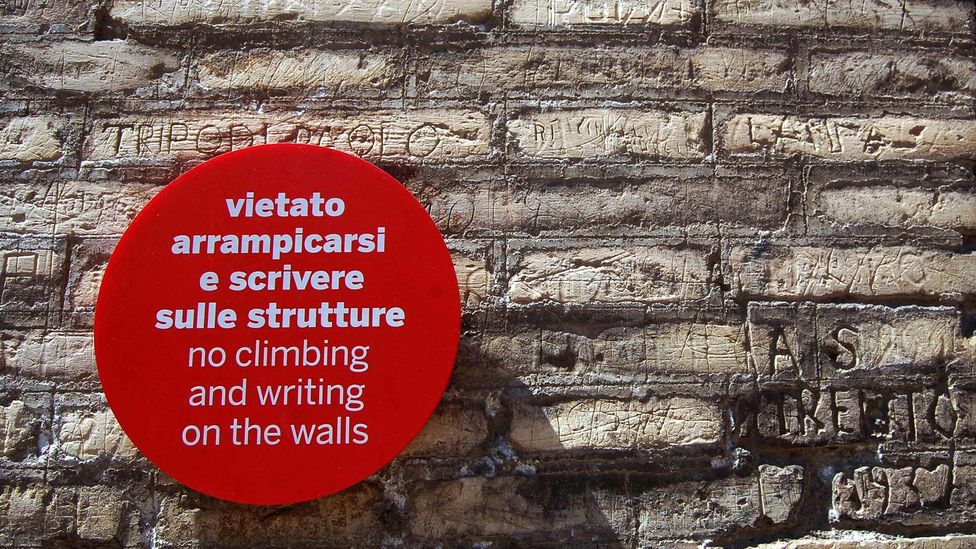 Signs at many of Italy's famous monuments now beg tourists to not deface them (Credit: mark mcconkey/Alamy)